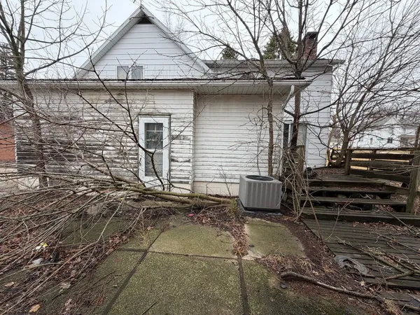 a view of a house with a door and wooden walls