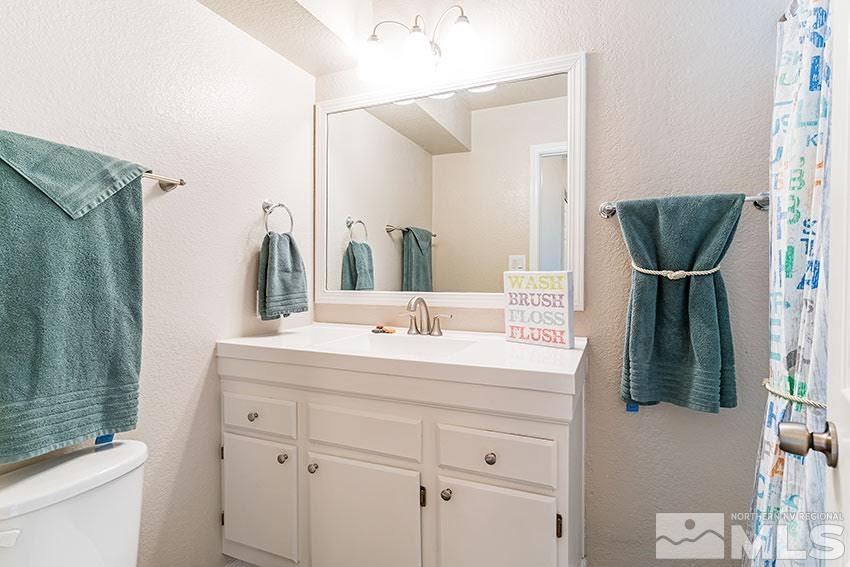 530 Tarn Way Reno, NV 89503 - Photo 17 of 25 a bathroom with a sink and a mirror