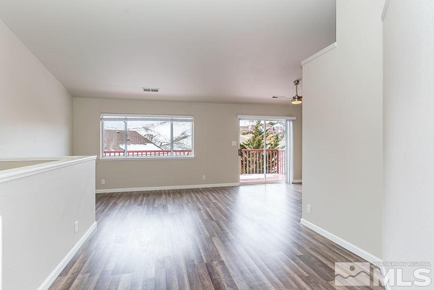 530 Tarn Way Reno, NV 89503 - Photo 4 of 25 an empty room with wooden floor and windows