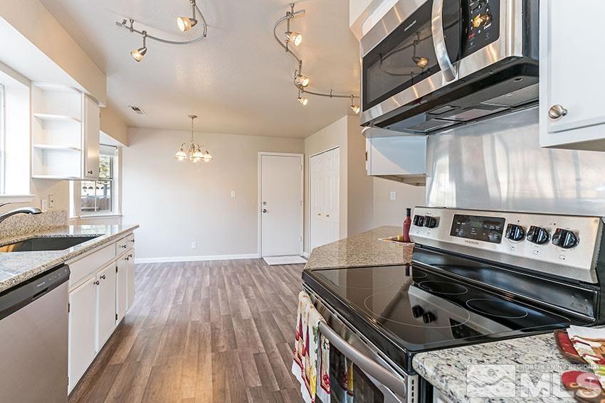 530 Tarn Way Reno, NV 89503 - Photo 8 of 25 a kitchen with granite countertop a stove and a sink