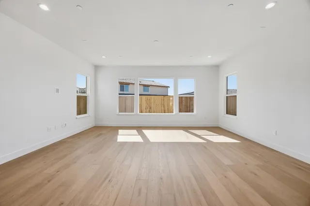 a large kitchen with stainless steel appliances a refrigerator and a stove top oven