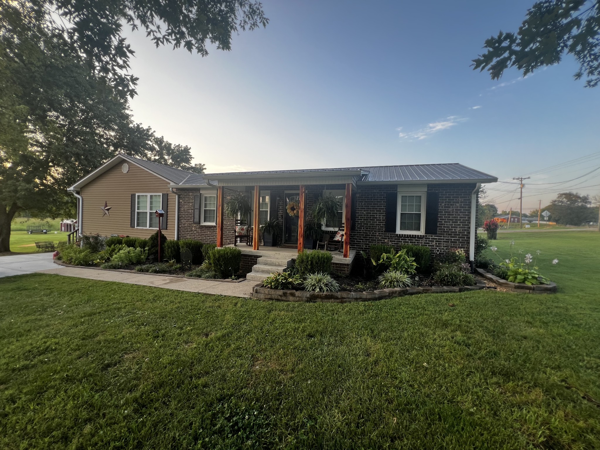 2491 Lassiter Road Readyville, TN 37149 - Photo 1 of 36 a front view of a house with a yard and outdoor seating