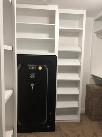 a view of walk in closet with empty racks