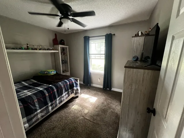 a bedroom with a bed and a mirror