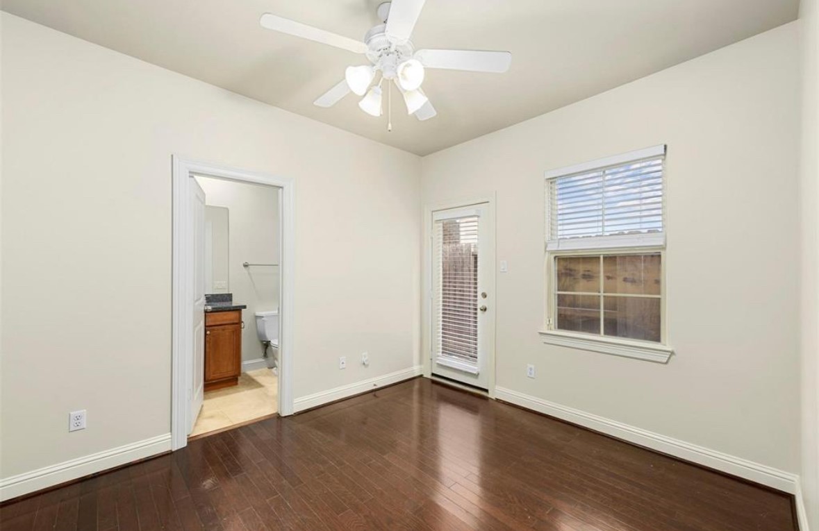1215 Roberts Street Houston, TX 77003 - Photo 15 of 20 an empty room with wooden floor chandelier fan and windows