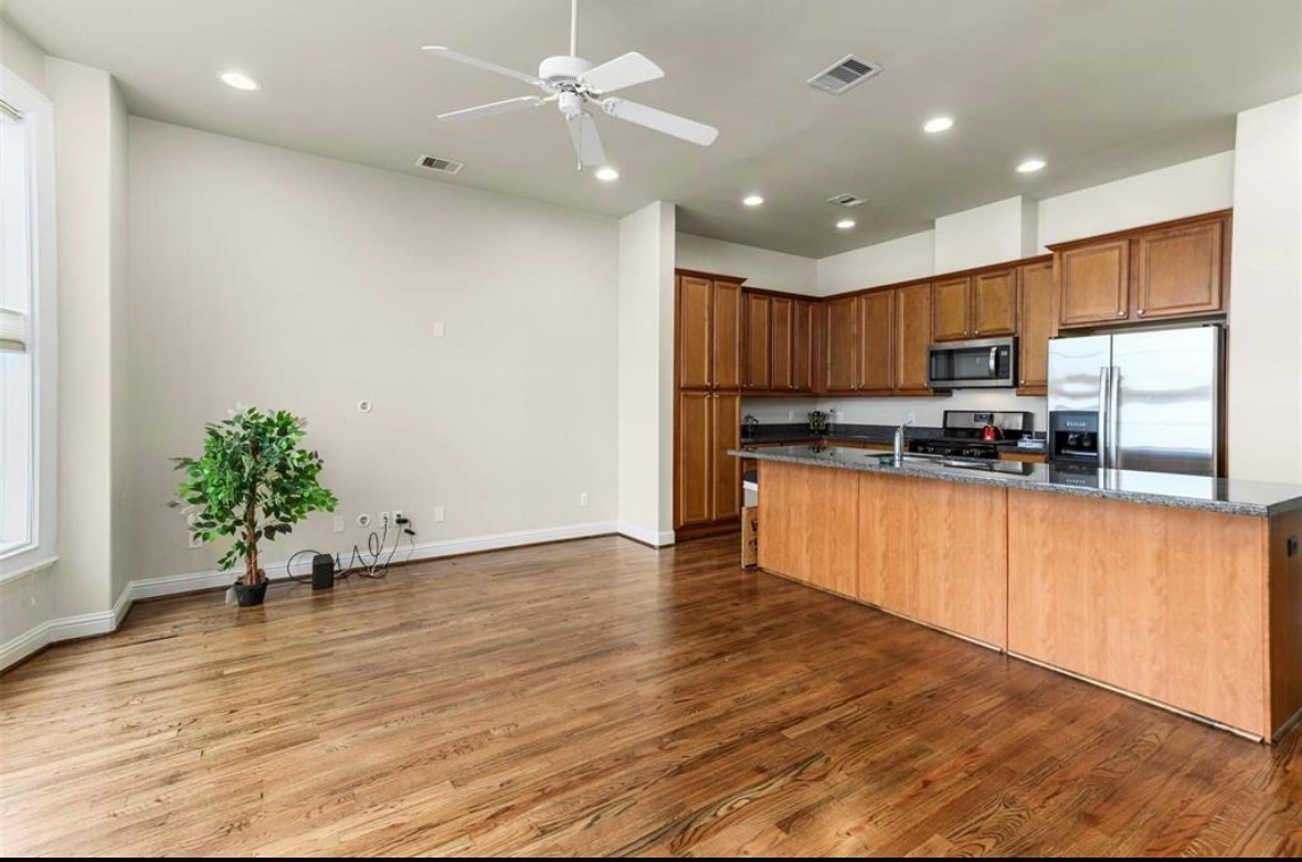 1215 Roberts Street Houston, TX 77003 - Photo 16 of 20 a kitchen with stainless steel appliances granite countertop a refrigerator a stove a sink and a microwave