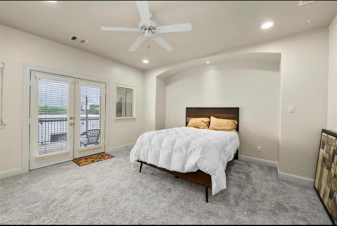 1215 Roberts Street Houston, TX 77003 - Photo 18 of 20 a spacious bedroom with a bed and a large window