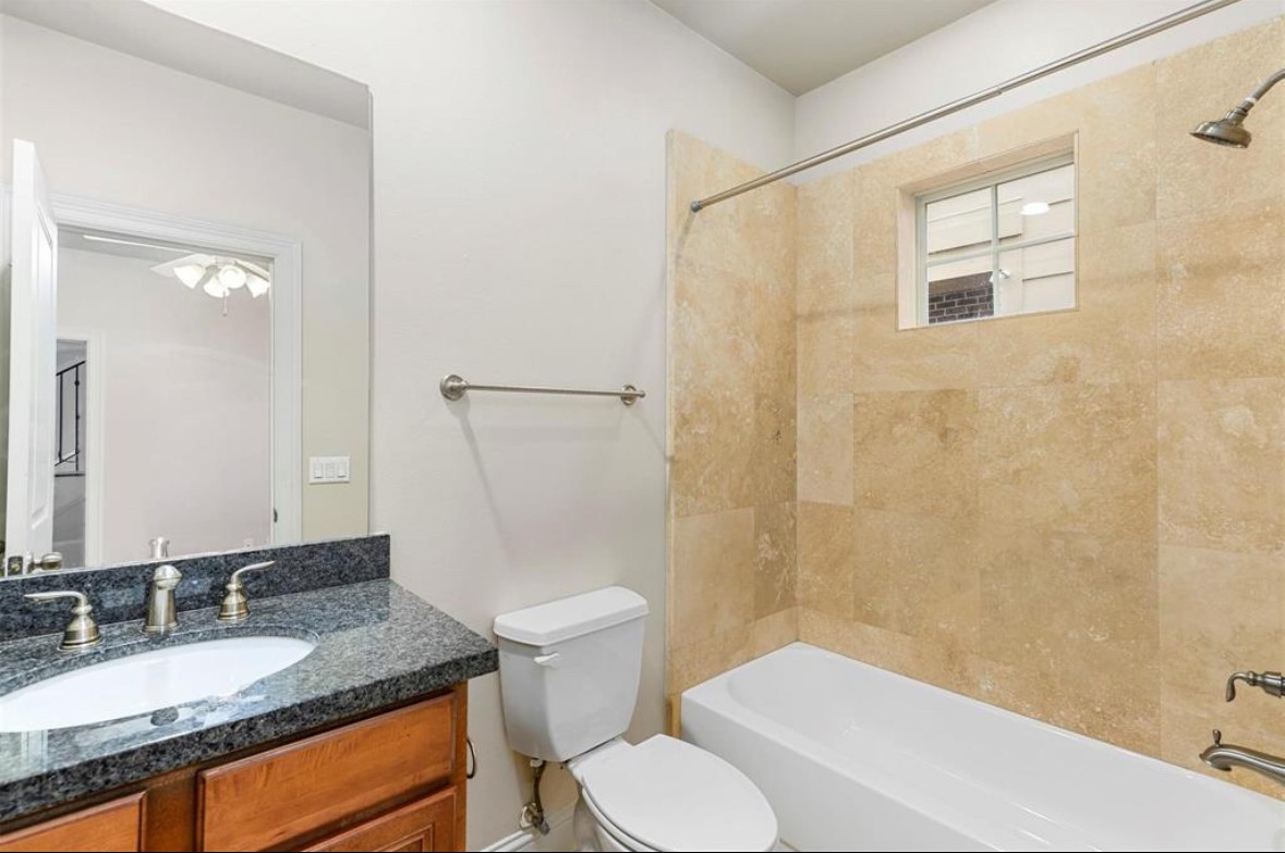 1215 Roberts Street Houston, TX 77003 - Photo 7 of 20 a bathroom with a granite countertop sink toilet and shower