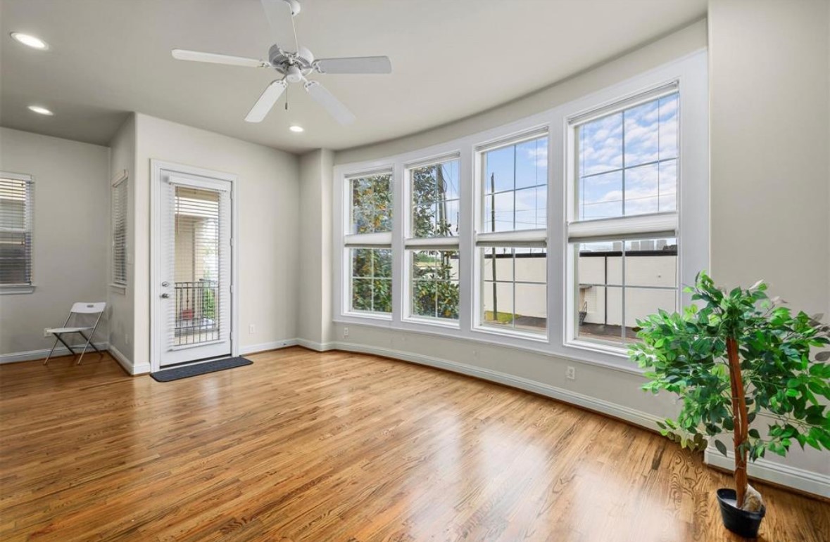 1215 Roberts Street Houston, TX 77003 - Photo 8 of 20 a view of an empty room with a window and wooden floor