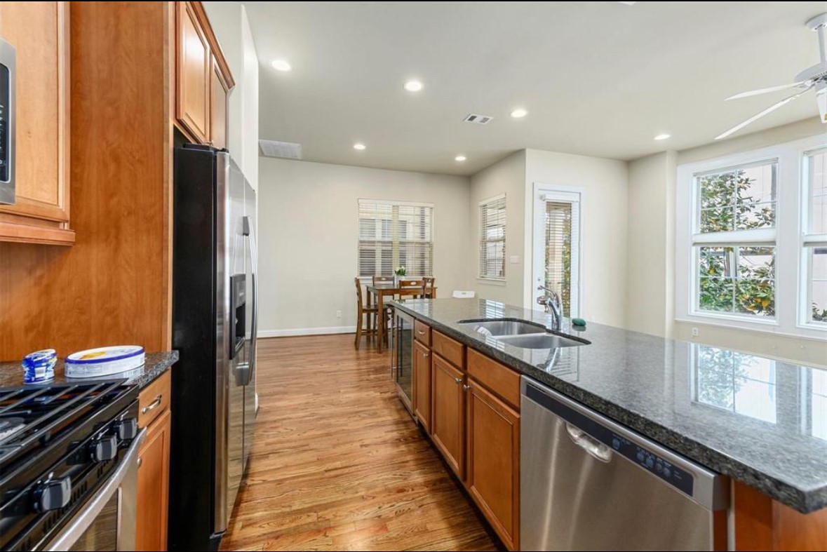 1215 Roberts Street Houston, TX 77003 - Photo 10 of 20 a large kitchen with stainless steel appliances a large counter top a stove and a refrigerator