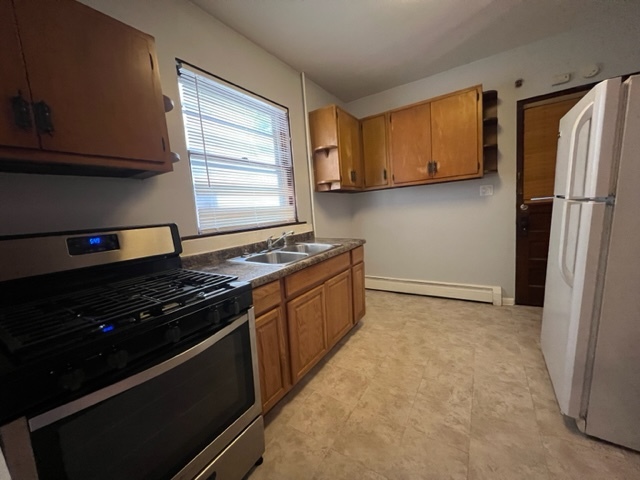 532 South Street Elgin, IL 60123 - Photo 2 of 43 a kitchen with stainless steel appliances a stove a refrigerator and cabinets