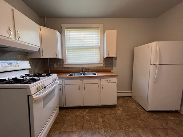 532 South Street Elgin, IL 60123 - Photo 21 of 43 a kitchen with a white stove top oven and refrigerator