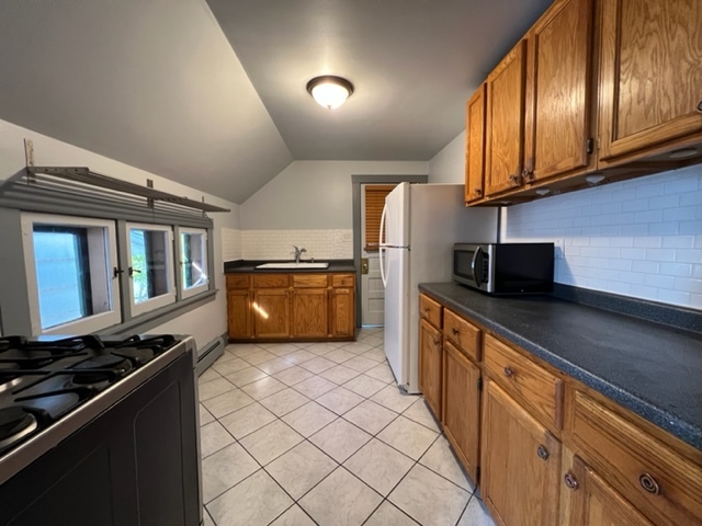 532 South Street Elgin, IL 60123 - Photo 23 of 43 a kitchen with stainless steel appliances granite countertop a stove a sink and a refrigerator