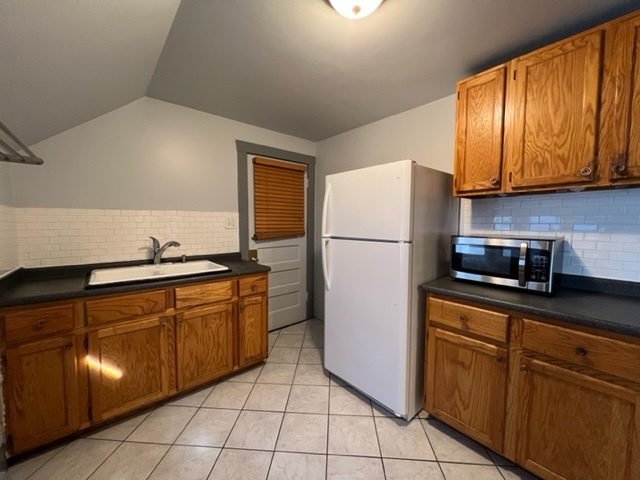 532 South Street Elgin, IL 60123 - Photo 27 of 43 a kitchen with stainless steel appliances granite countertop a refrigerator sink and cabinets
