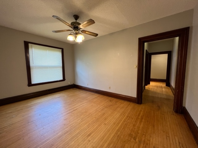 532 South Street Elgin, IL 60123 - Photo 38 of 43 a view of an empty room with wooden floor and a ceiling fan