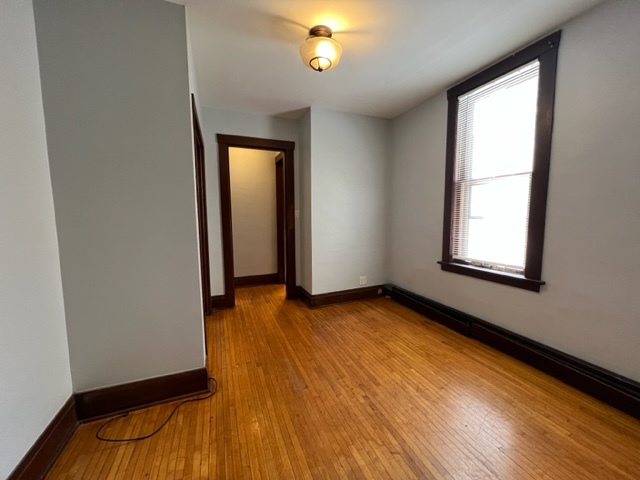 532 South Street Elgin, IL 60123 - Photo 4 of 43 a view of an empty room with window and wooden floor