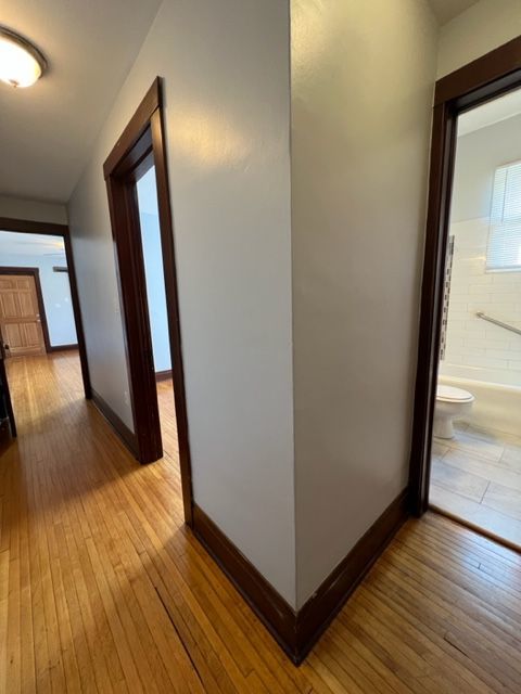 532 South Street Elgin, IL 60123 - Photo 7 of 43 a view of a hallway with wooden floor and stairs