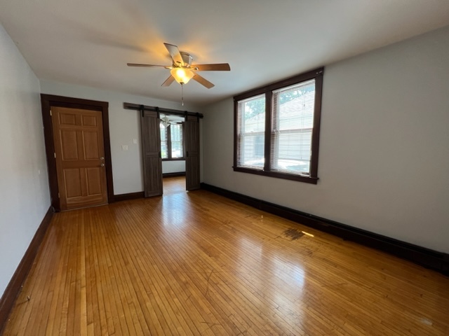 532 South Street Elgin, IL 60123 - Photo 9 of 43 a view of an empty room with wooden floor and a window