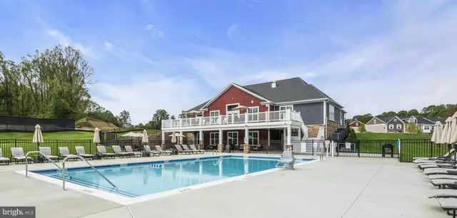 a front view of a house with a yard table and chairs