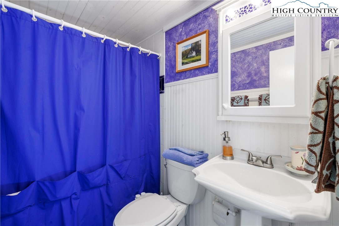 108 Northridge Road, Unit 3A Beech Mountain, NC 28604 - Photo 11 of 23 a bathroom with a toilet a sink and a mirror