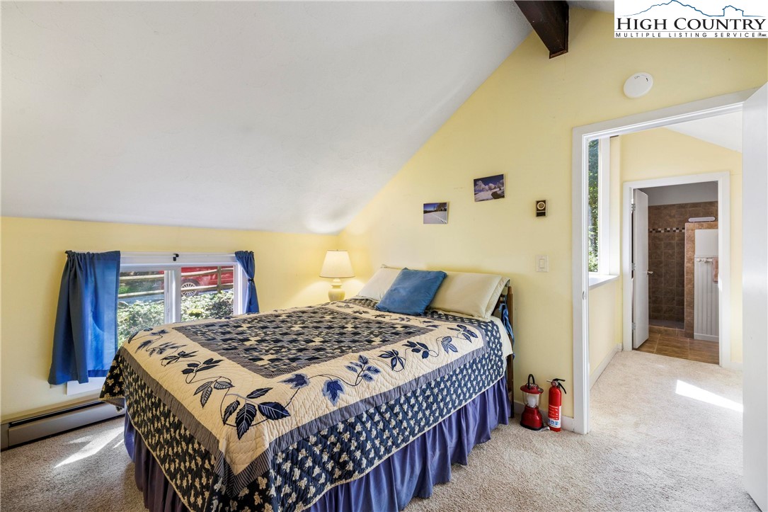 108 Northridge Road, Unit 3A Beech Mountain, NC 28604 - Photo 15 of 23 a bedroom with a bed and a table in it