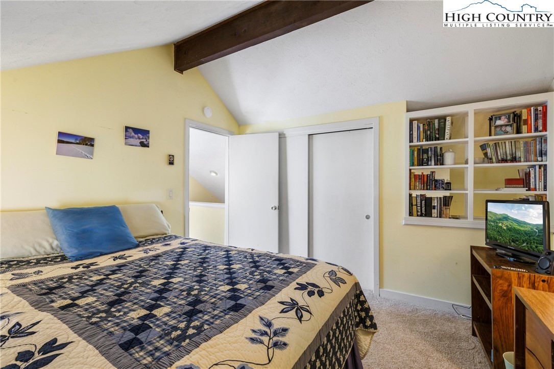108 Northridge Road, Unit 3A Beech Mountain, NC 28604 - Photo 16 of 23 a bedroom with a bed and a flat screen tv