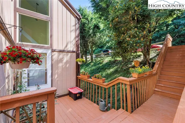 a view of a pathway of a house with wooden fence and floor