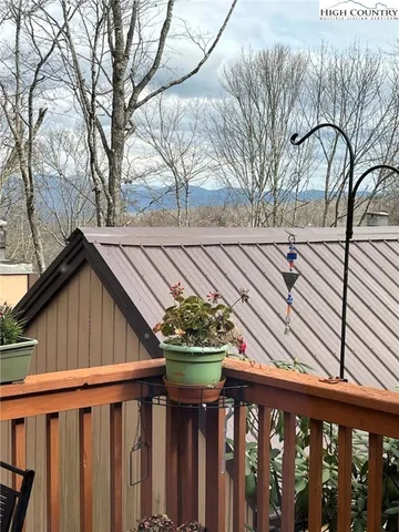 a view of a lush green field with mountains in the background