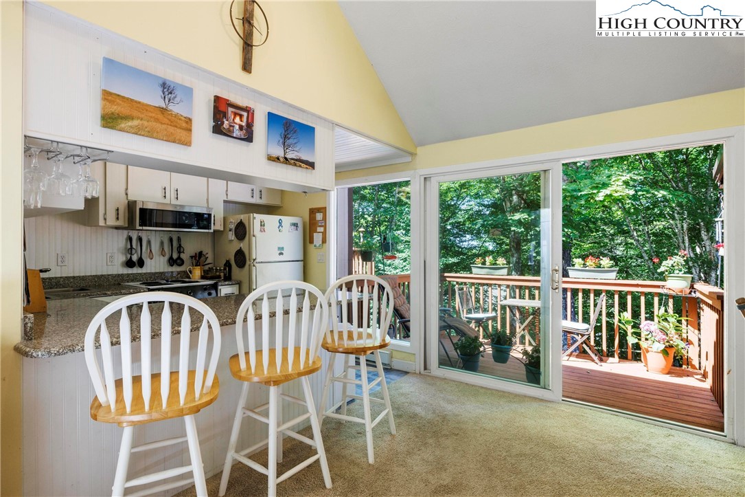 108 Northridge Road, Unit 3A Beech Mountain, NC 28604 - Photo 3 of 23 a view of a patio with a table and chairs