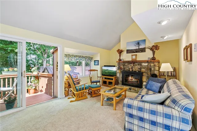 a living room with furniture and a floor to ceiling window