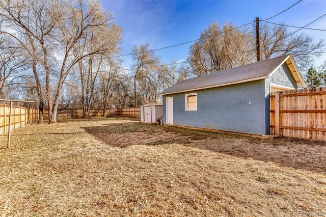 a backyard of a house with large trees