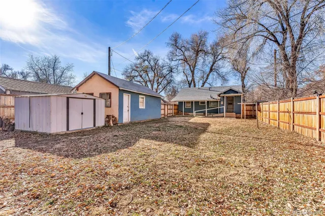 a front view of a house with a large tree