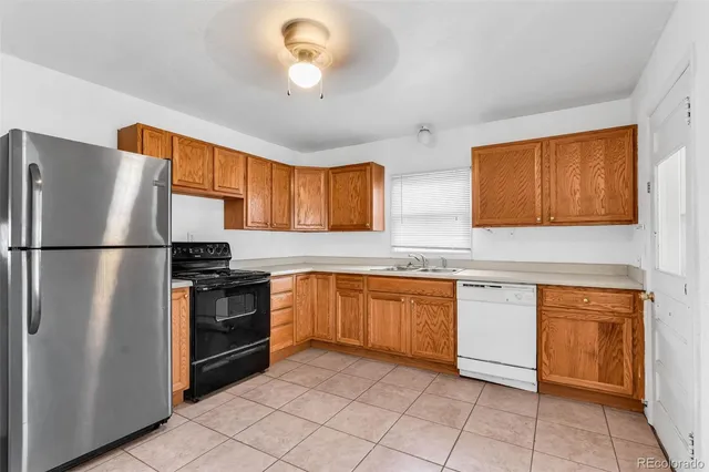 a kitchen with stainless steel appliances granite countertop a refrigerator sink and cabinets
