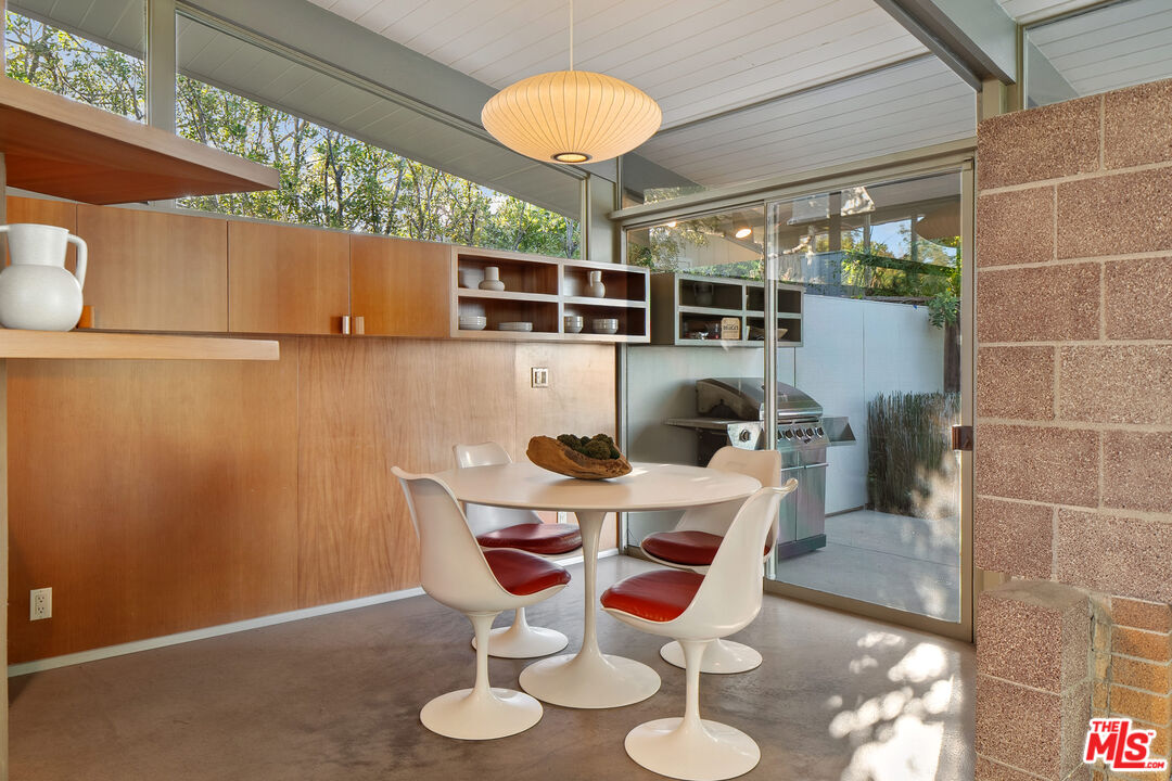 12412 Deerbrook Lane Los Angeles, CA 90049 - Photo 12 of 30 a view of a dining room with furniture and wooden floor