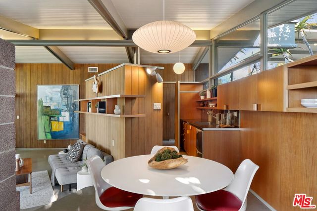 a dining room with furniture and wooden floor