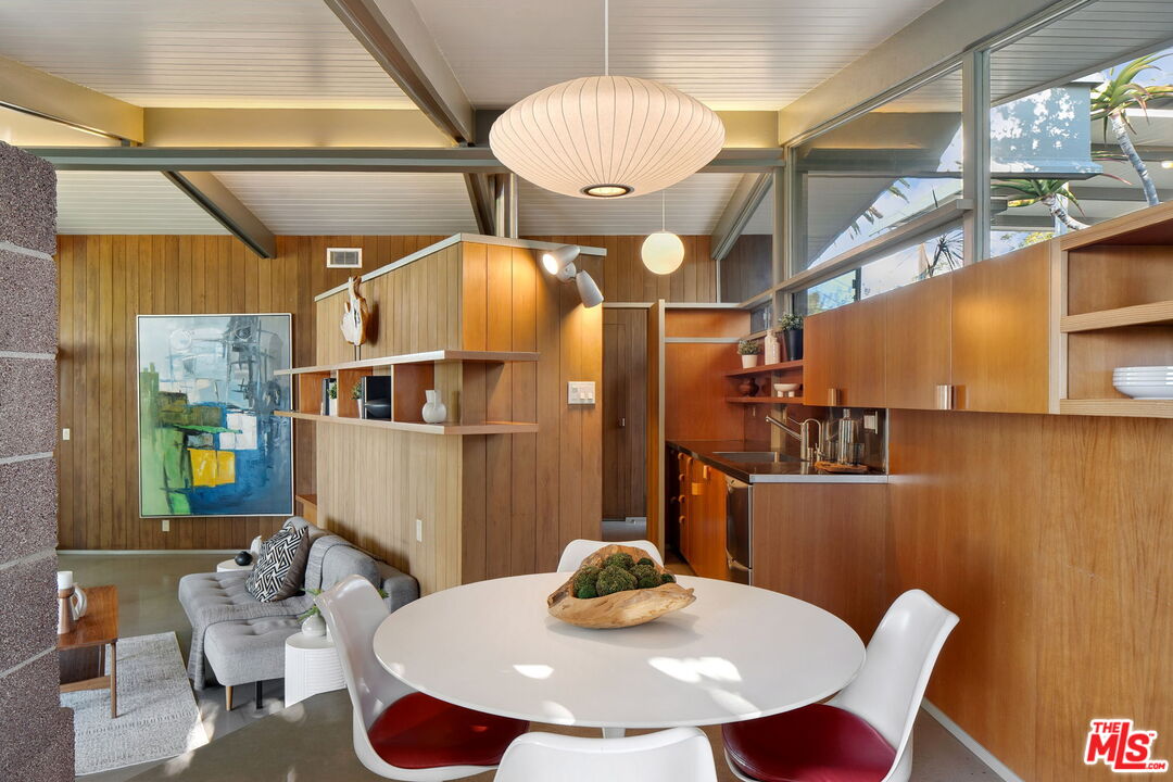 12412 Deerbrook Lane Los Angeles, CA 90049 - Photo 13 of 30 a dining room with furniture and wooden floor