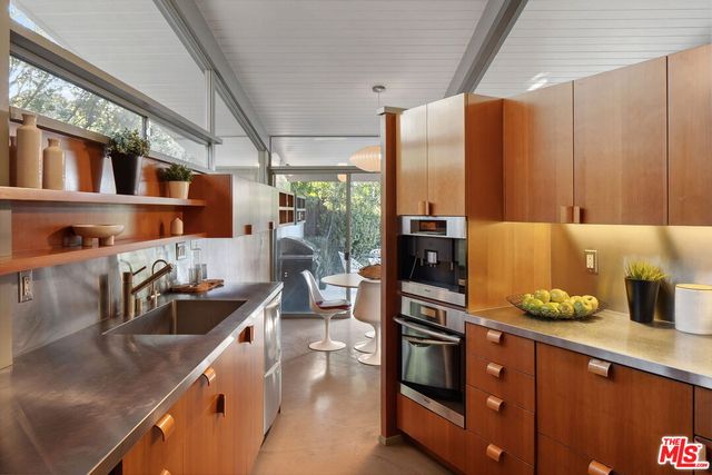 a kitchen with counter top space and stainless steel appliances