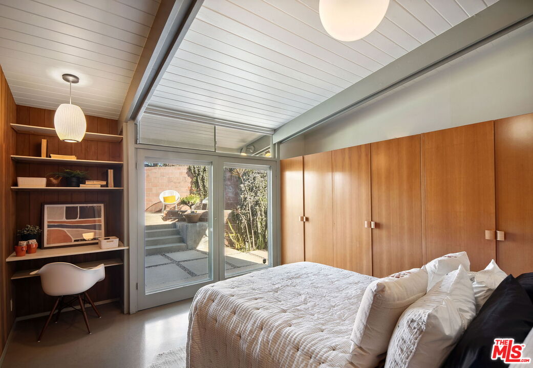 12412 Deerbrook Lane Los Angeles, CA 90049 - Photo 16 of 30 a bedroom with a bed and a chair