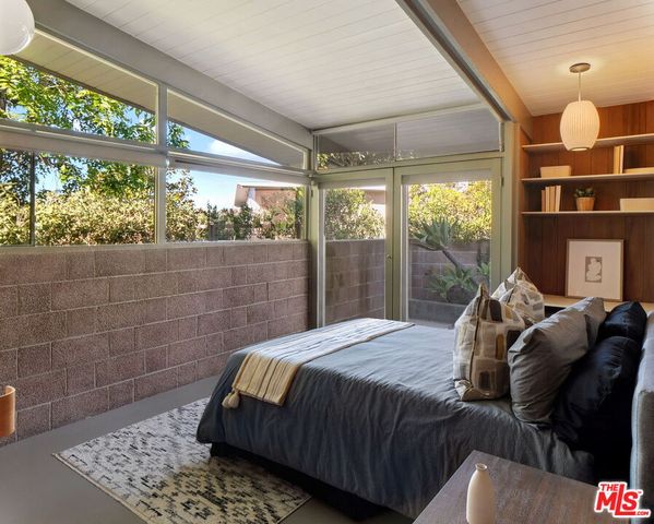 a bedroom with a bed and window