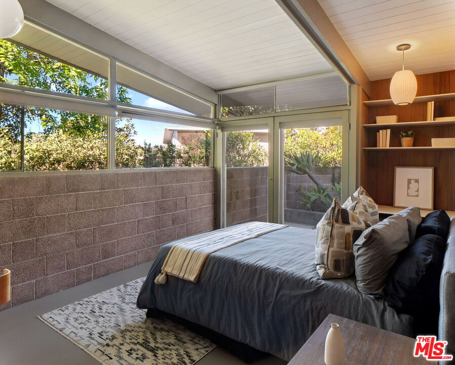 12412 Deerbrook Lane Los Angeles, CA 90049 - Photo 17 of 30 a bedroom with a bed and window