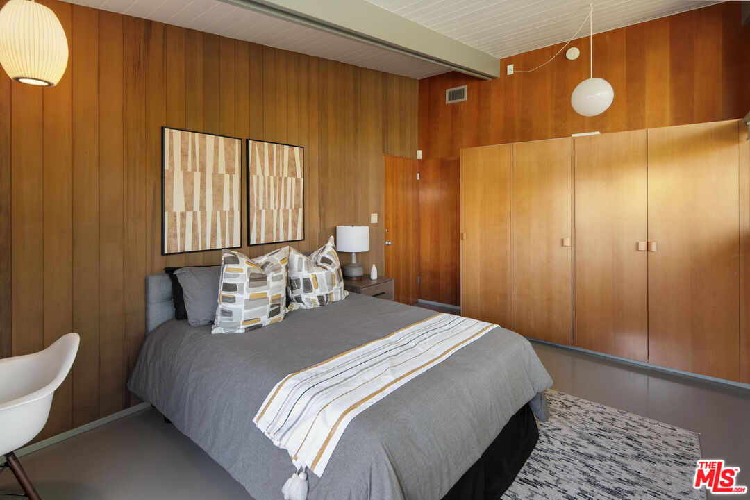 12412 Deerbrook Lane Los Angeles, CA 90049 - Photo 18 of 30 a bed sitting in a bedroom next to a bathroom