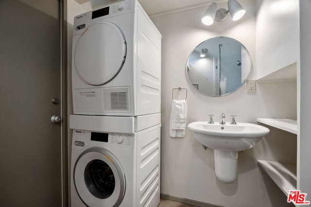 a bathroom with a sink mirror and toilet