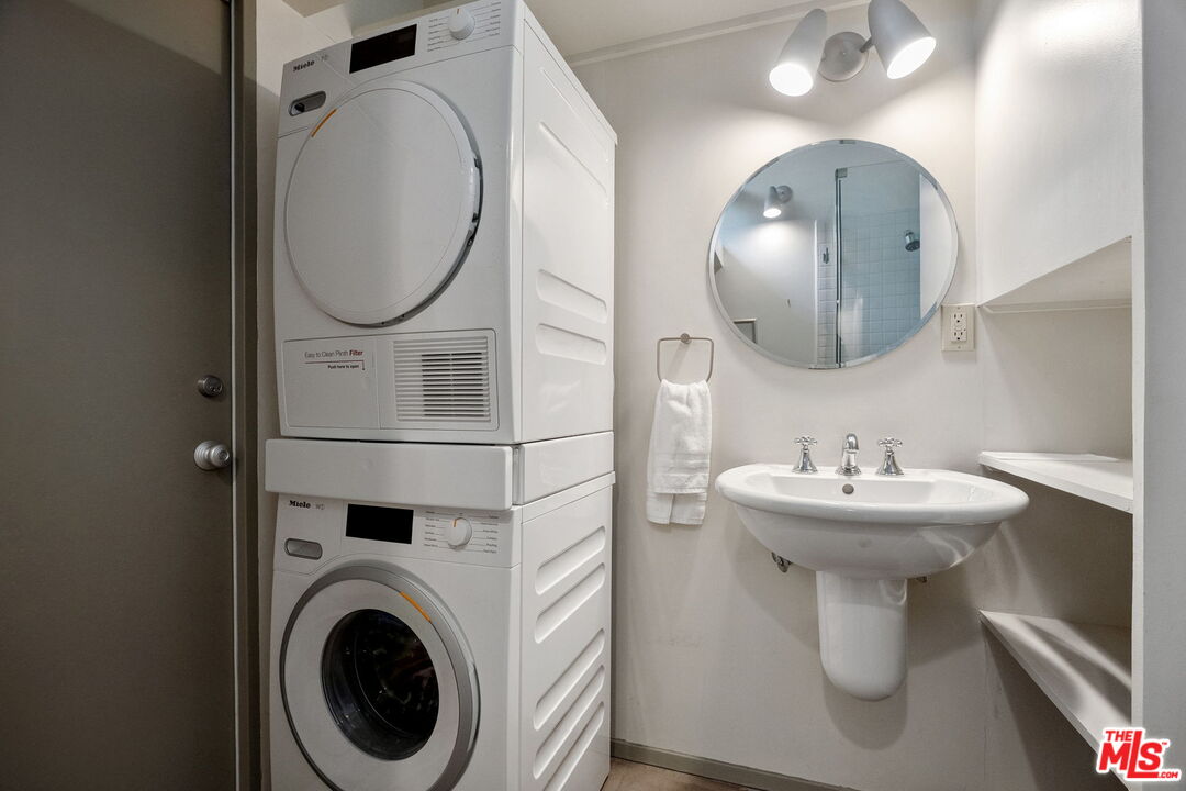 12412 Deerbrook Lane Los Angeles, CA 90049 - Photo 21 of 30 a bathroom with a sink mirror and toilet