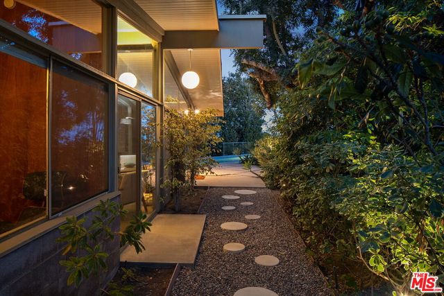 a backyard of a house with a yard and outdoor seating
