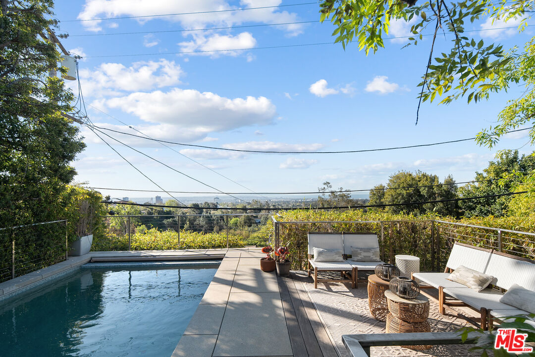 12412 Deerbrook Lane Los Angeles, CA 90049 - Photo 28 of 30 a view of a swimming pool with a patio and a garden