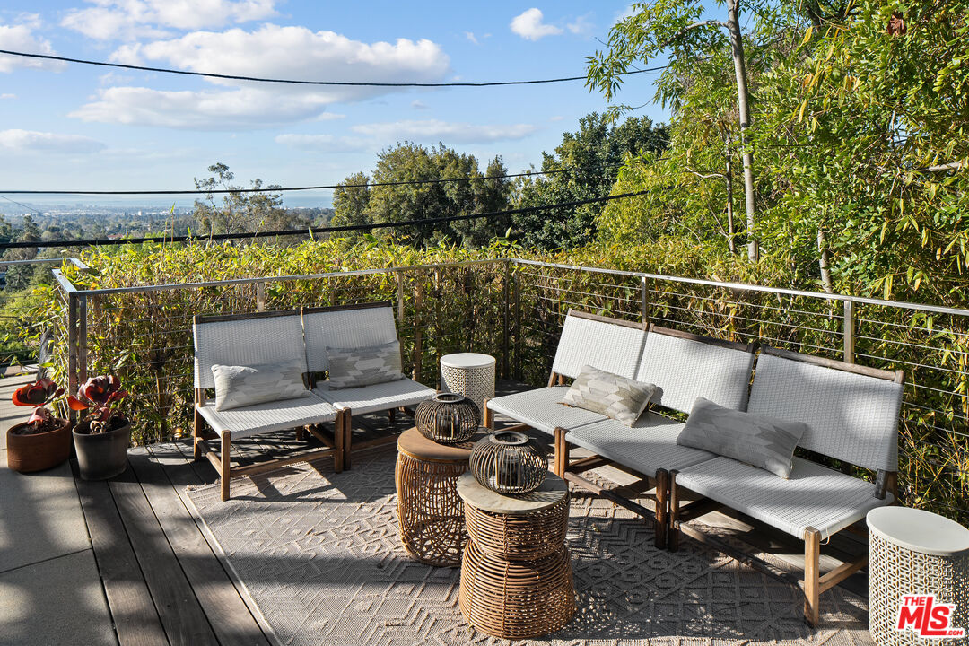 12412 Deerbrook Lane Los Angeles, CA 90049 - Photo 29 of 30 a roof deck with table and chairs