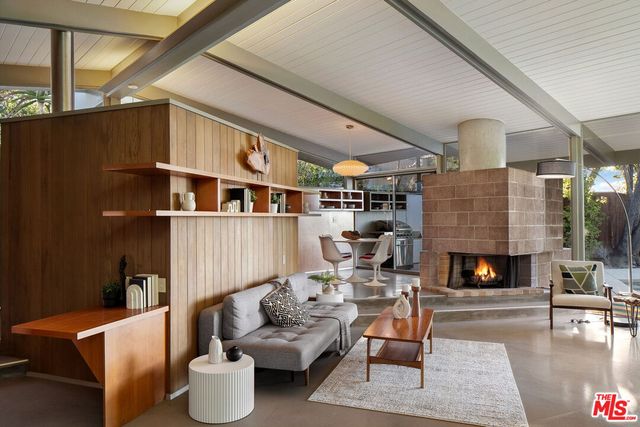 a living room with furniture and fireplace