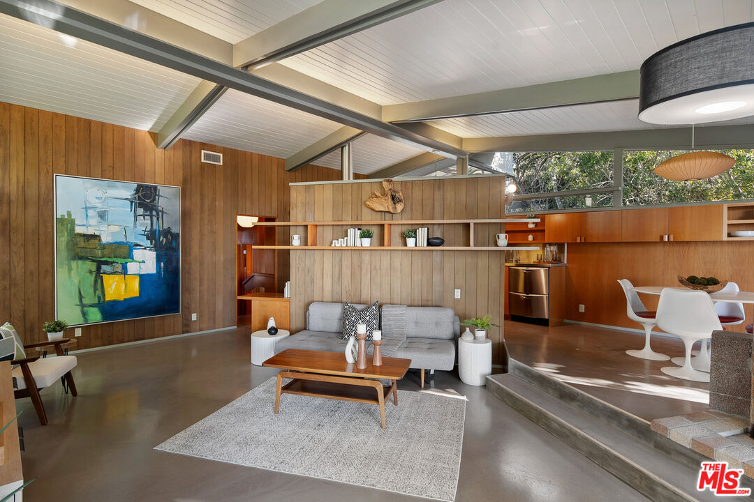 12412 Deerbrook Lane Los Angeles, CA 90049 - Photo 7 of 30 a reading room with furniture and a large window