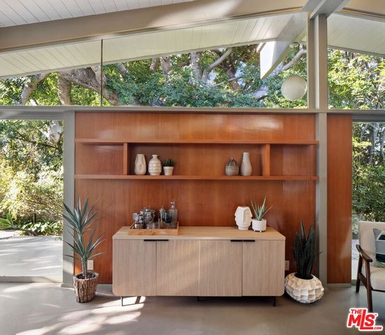 a room with a table chair and a window