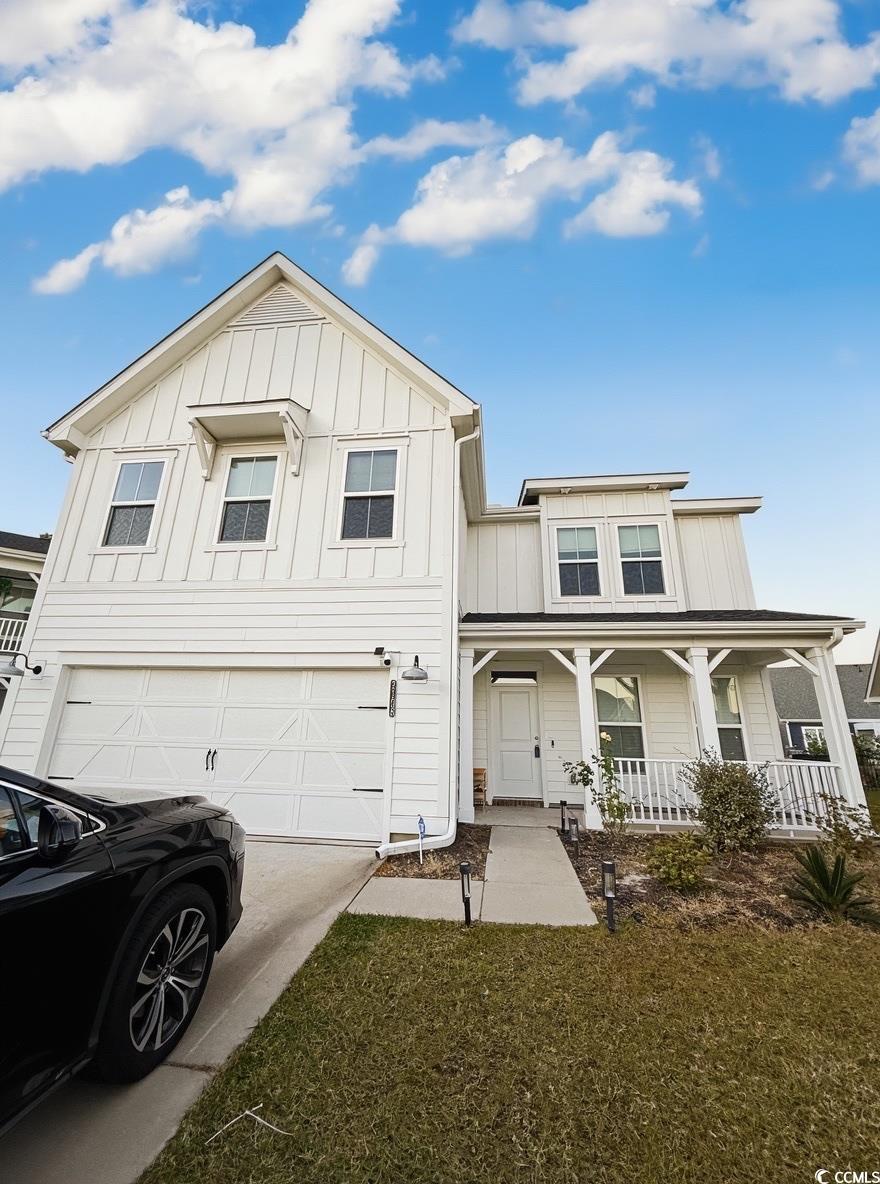 2108 Ballast Court Myrtle Beach, SC 29579 - Photo 2 of 37 Modern inspired farmhouse featuring board and batten siding, driveway, covered porch, an attached garage, and a front lawn